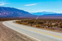 Road going through the arid and mountainous landscape of Los Cardones National Park; Salta Province, Argentina — Stock Photo