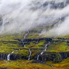 Waterfalls flowing over a mountainside; Djupivogur, Eastern Region, Iceland — Stock Photo
