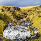 Skogafoss one of Icelands biggest and most beautiful waterfalls with an astounding width of 25 meters and a drop of 60 meters; Rangarping eystra, Southern Region, Iceland — Stock Photo