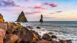 Sea stacks and tranquil ocean water along the coast of Southern Iceland; Myrdalshreppur, Southern Region, Iceland — Stock Photo