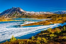 Half frozen Lost Lake in the morning, Chugach Mountains in the background. Chugach National Forest, Kenai Peninsula, South-central Alaska in springtime; Seward, Alaska, United States of America — Stock Photo