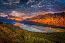 Aerial view of the sunset glow on Chugach Mountains, and reflection on Eklutna Lake, Chugach State Park, South-central Alaska in summertime; Alaska, United States of America — Stock Photo