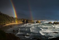 Rainbow Seen Through Storm Clouds Over Crescent Beach; Cannon Beach, Oregon, Estados Unidos da América — Fotografia de Stock