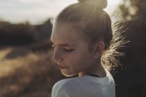 Close-up portrait of a preteen girl backlit by the sunlight; Los Angeles, California, United States of America — Stock Photo