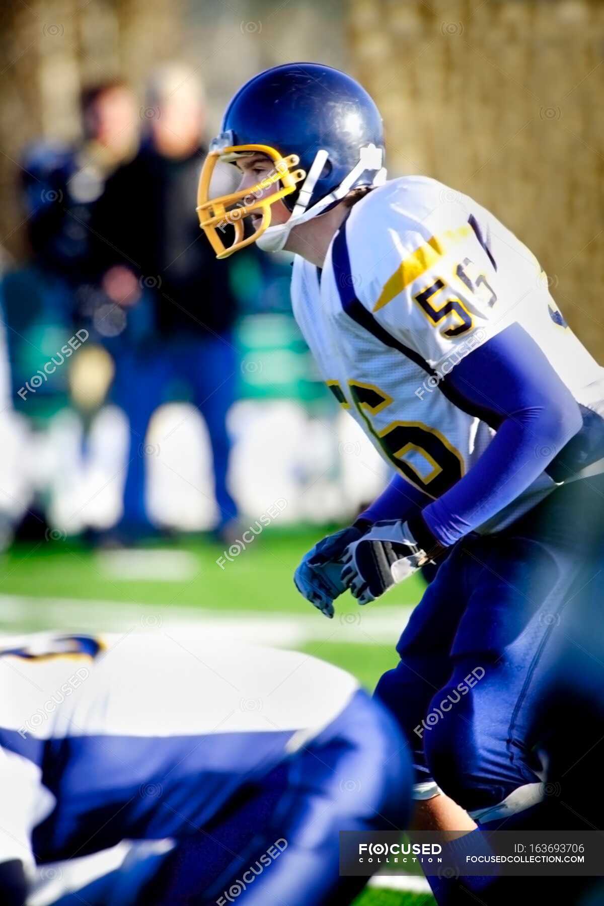 Side View of Young Football Player in Uniform — teenagers, team sport ...