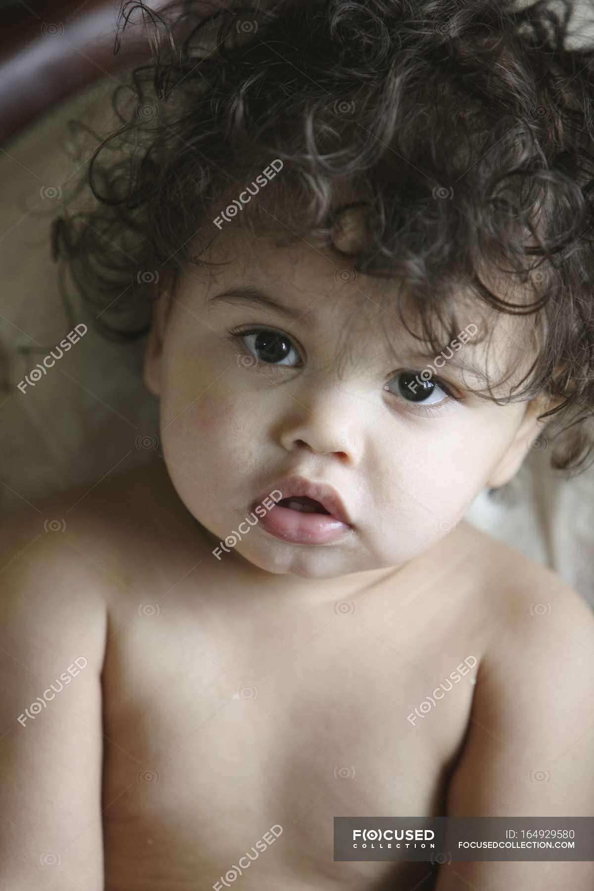 Portrait Of Young Baby Girl With Dark Curly Hair — person, childhood -  Stock Photo | #164929580