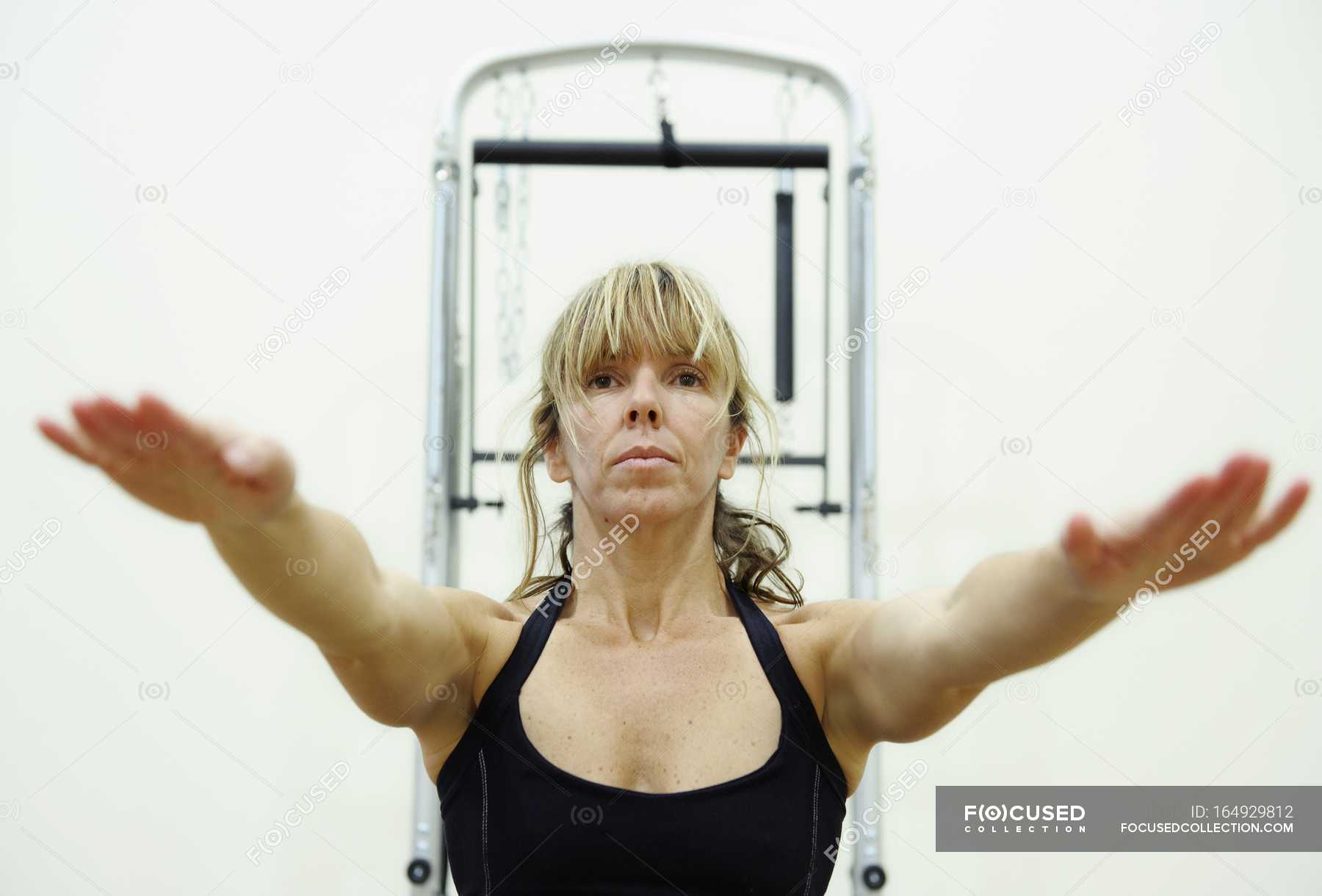 Ben WelshMature Woman Exercising At Gym