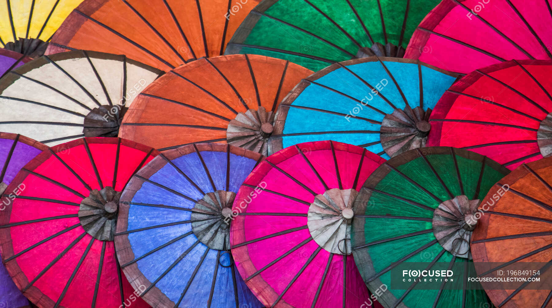 Bright coloured paper umbrellas for sale at the night market; Luang
