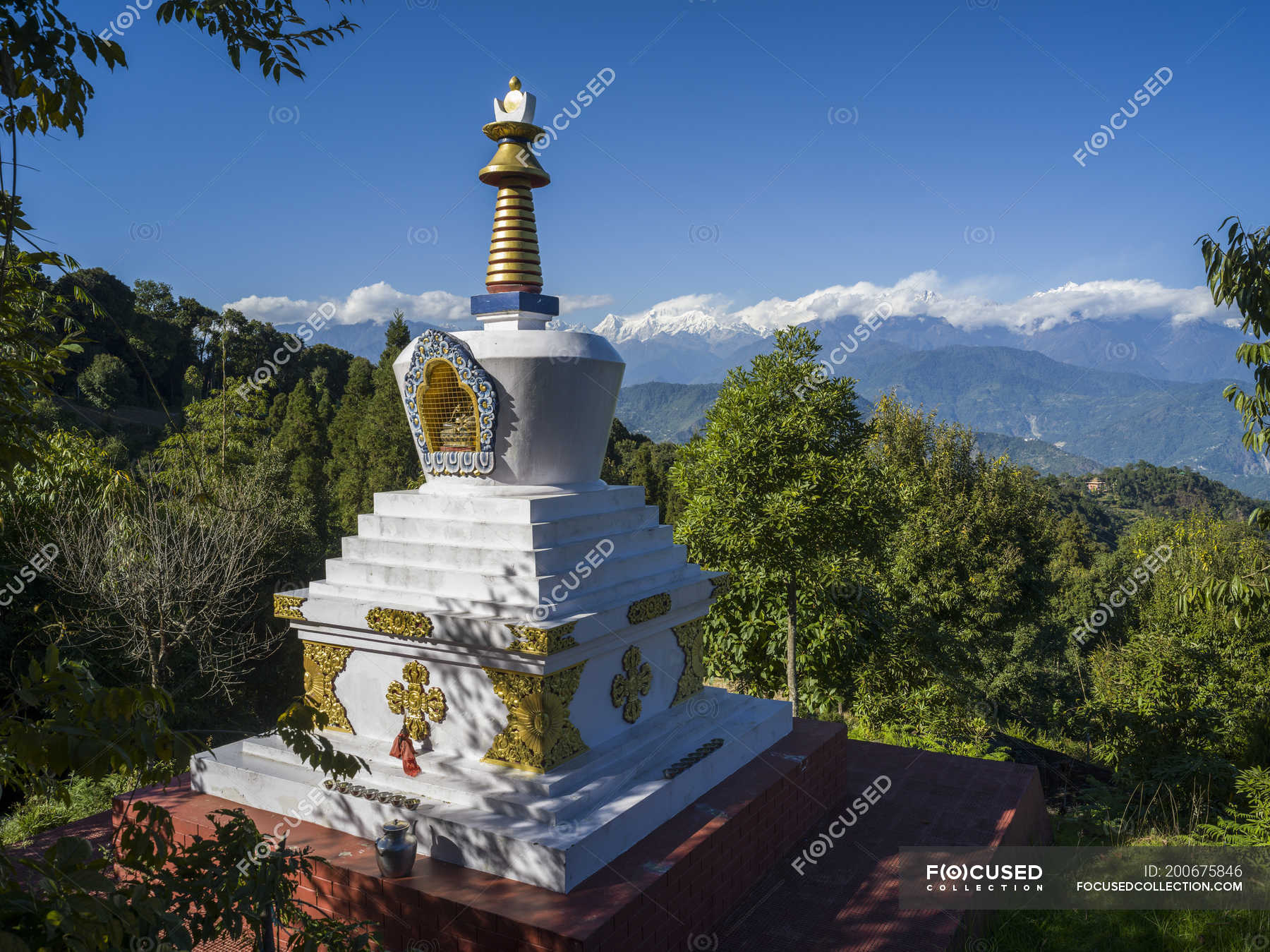 Decorative Buddhist monument on a mountainside with a view of the