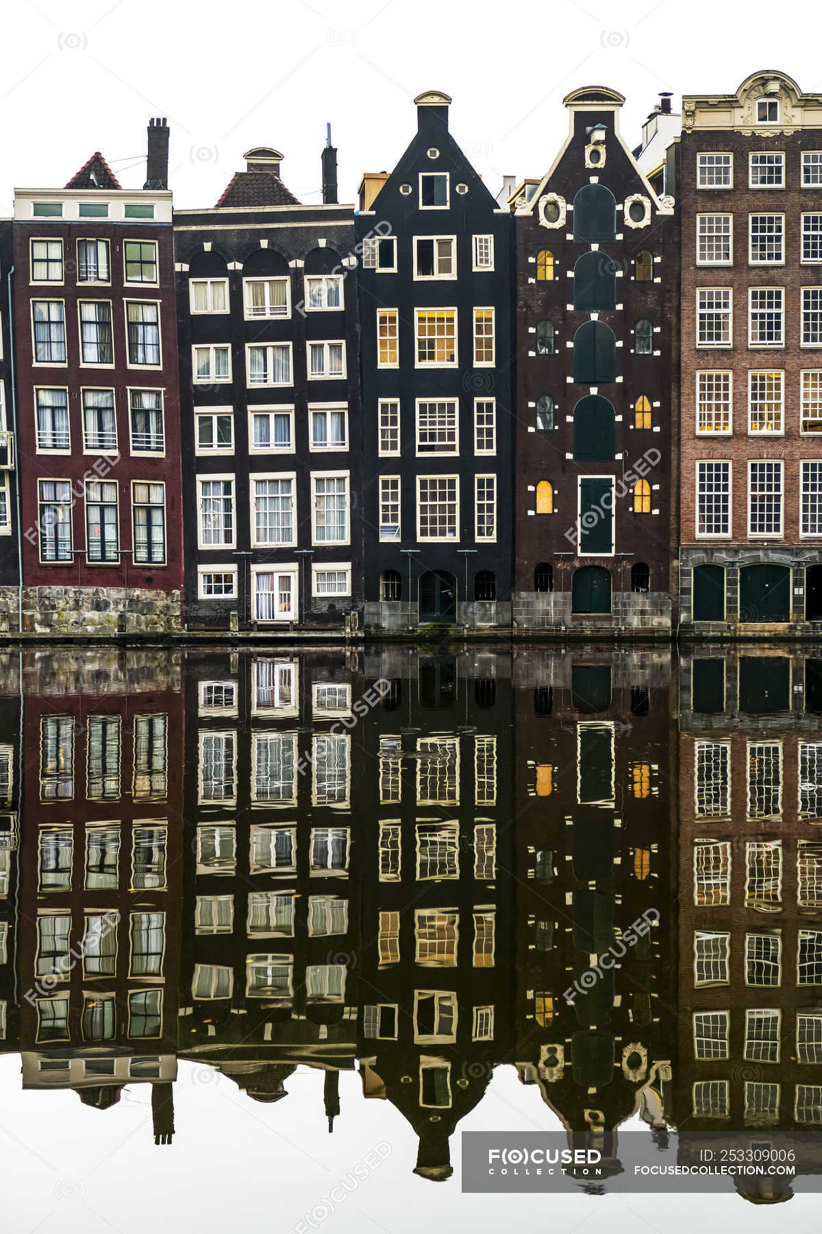 Building facades with a mirror image reflecting in a canal; Amsterdam, Netherlands — place of interest, buildings - Stock Photo #253309006
