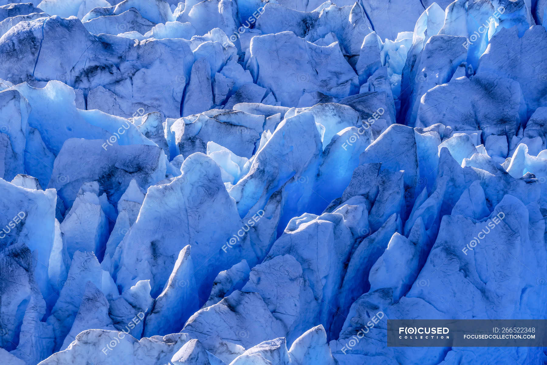 Blue glacial ice is exposed in crevasses on Hole in the Wall Glacier