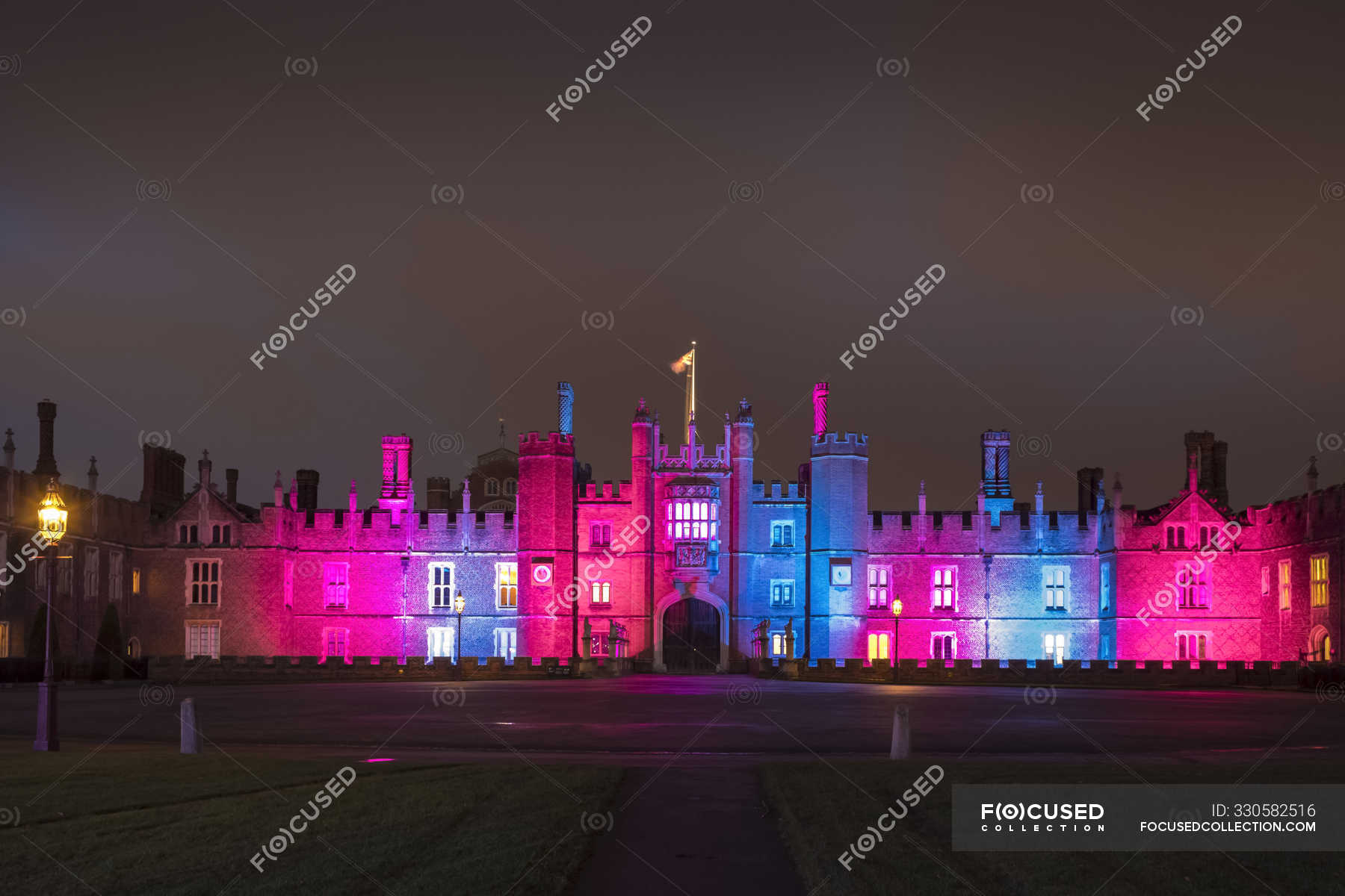 Scenic view of Hampton Court Palace with glowing Christmas lights