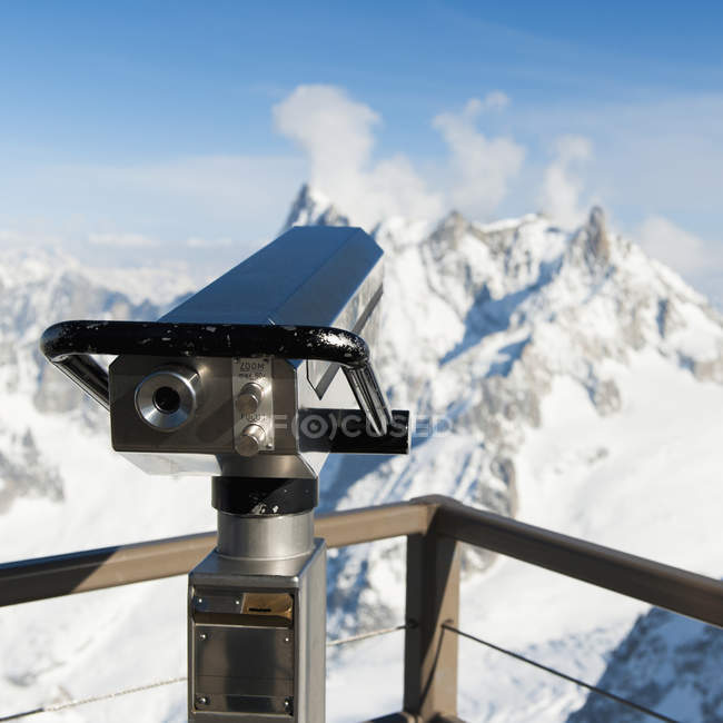 Binoculars with view of snow covered french alps — Stock Photo