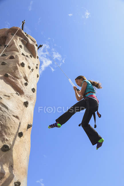 Girl on climbing wall — Stock Photo