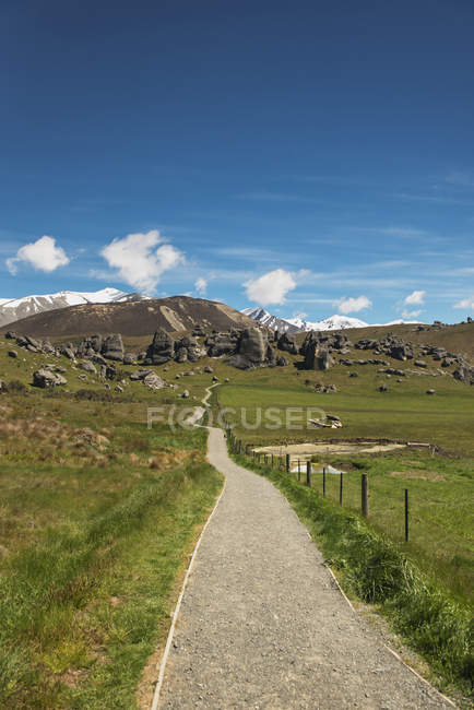 Rocky hill with field on foot — Stock Photo