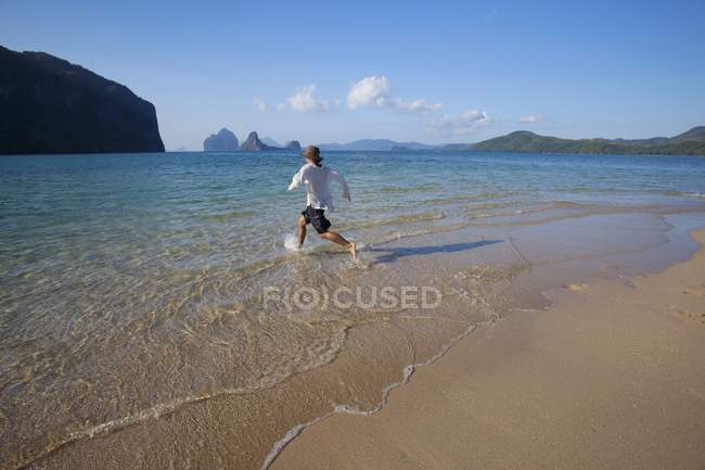 Man Wading Into Water — Stock Photo