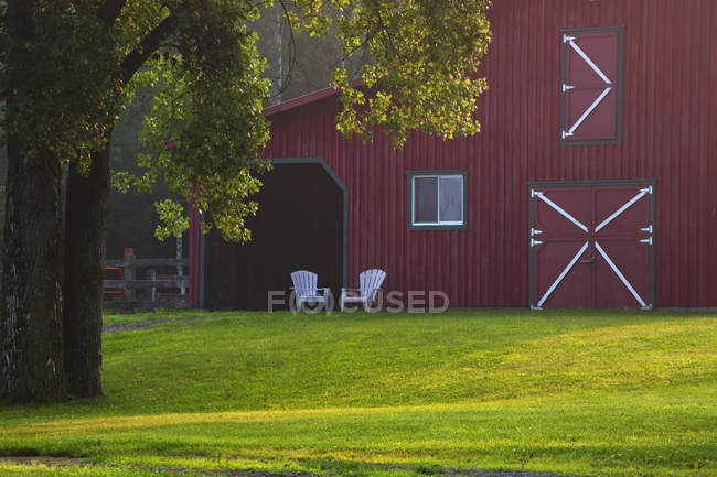 Red Barn With Two Chairs — Stock Photo