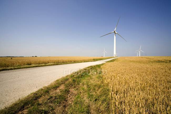 Wind Turbine against road — Stock Photo