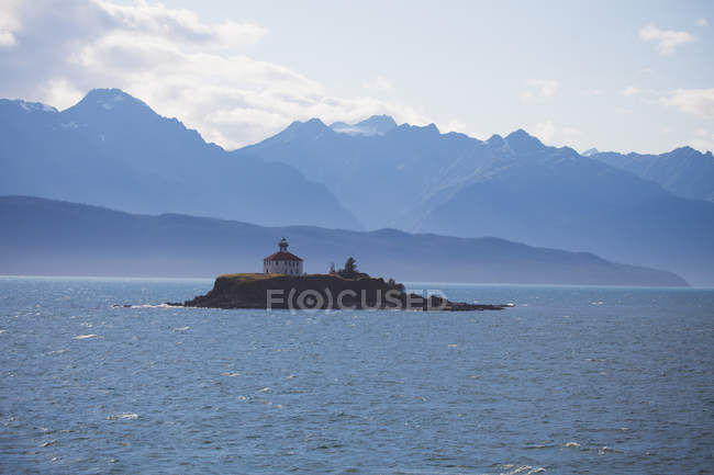 Lighthouse on small rock — Stock Photo