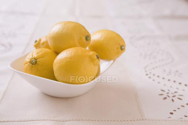 Cuenco blanco de limones - foto de stock