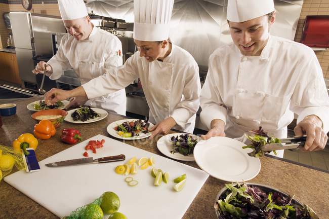Chefs Assembling Food — Stock Photo