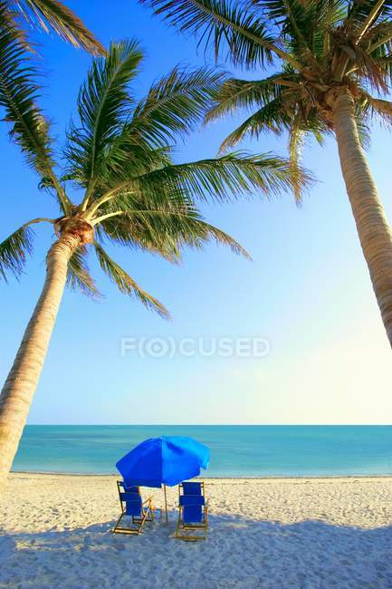 Chairs on sandy beach coast — Stock Photo