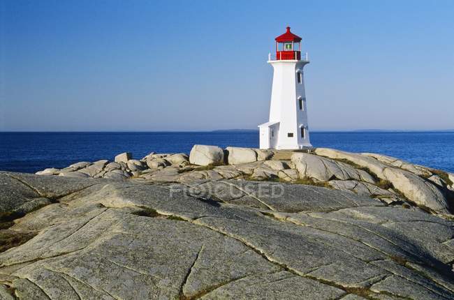 Lighthouse on top of rock — Stock Photo