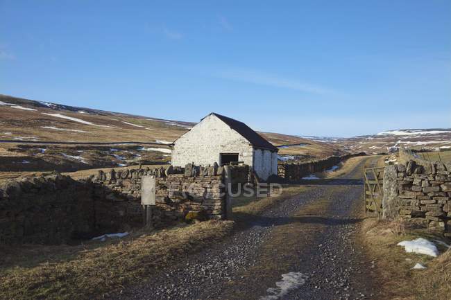 Casa ao longo da estrada rural — Fotografia de Stock