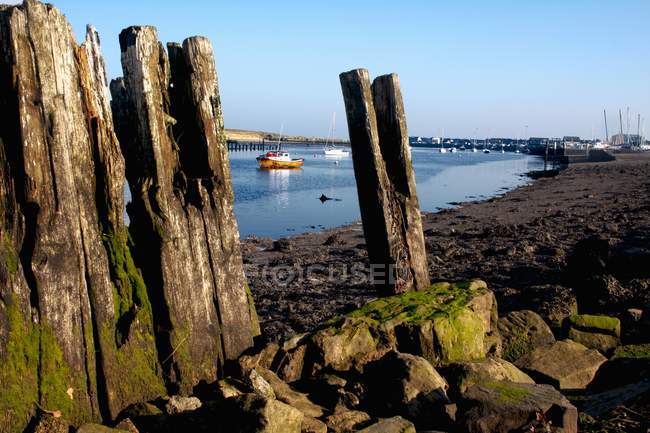 Stone columns against water — Stock Photo