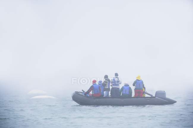 Tourists in rubber boat — Stock Photo