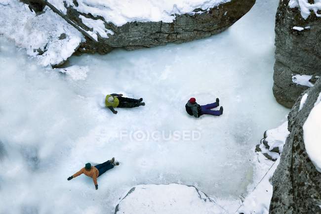 People Sliding Down Ice In Canyon — Stock Photo