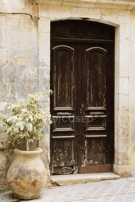 Wooden Door in wall of house — Stock Photo
