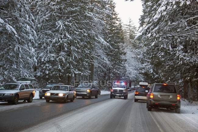 An Emergency Vehicle Makes It's Way Through Heavy Traffic After A Snow Storm On Mount Hood; Oregon, United States Of America — Stock Photo