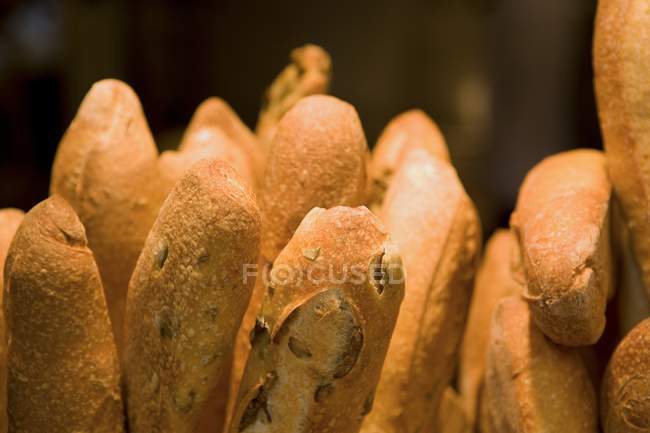 Stacks of fresh bread baguettes, closeup — Stock Photo