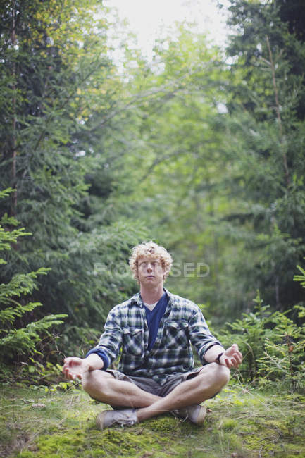 A Man Meditating In The Forest; France — Stock Photo