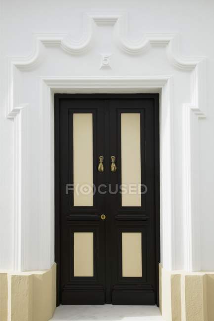 Black Door inside white wall — Stock Photo
