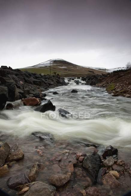 Río que fluye sobre rocas - foto de stock