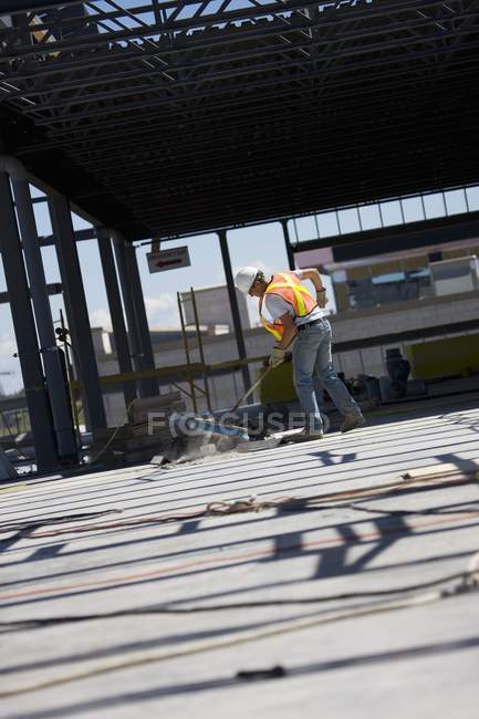 Worker Sweeping At Construction Site — Stock Photo
