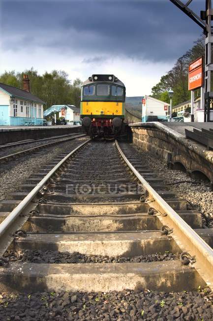 Train on railway at station — Stock Photo