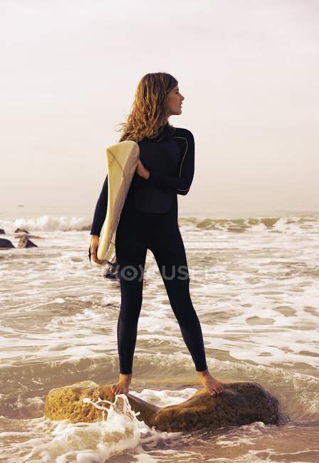 Young woman with surfboard at beach. Tarifa, Cadiz, Andalusia, Spain — Stock Photo