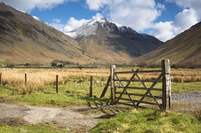 Fence In Farmland with mountains — Stock Photo