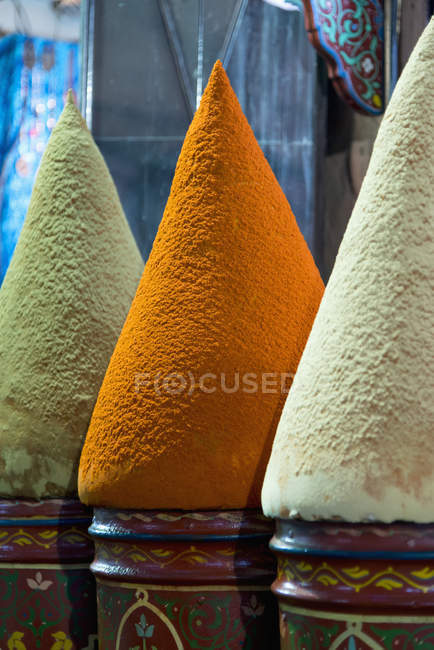 Colorful pots holding conical shapes on top — Stock Photo