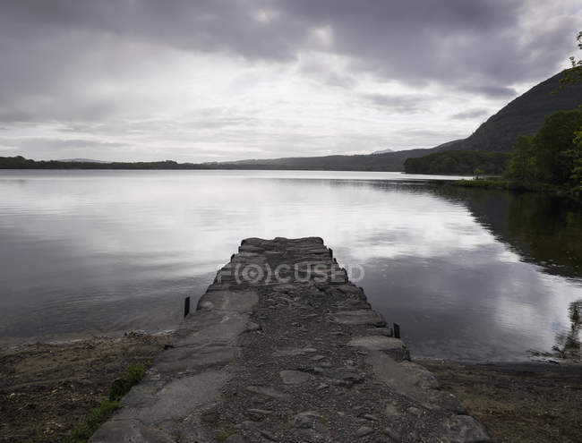 Stone dock at muckross lake — Stock Photo