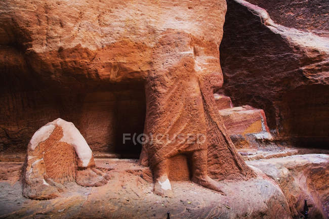 Rock carved into the lower half of a human body — Stock Photo