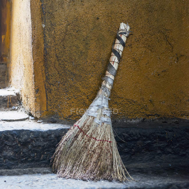 Broom sitting outside a doorway — Stock Photo