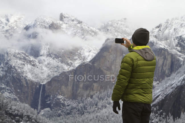 Man wearing green down jacket — view, color - Stock Photo | #165624114