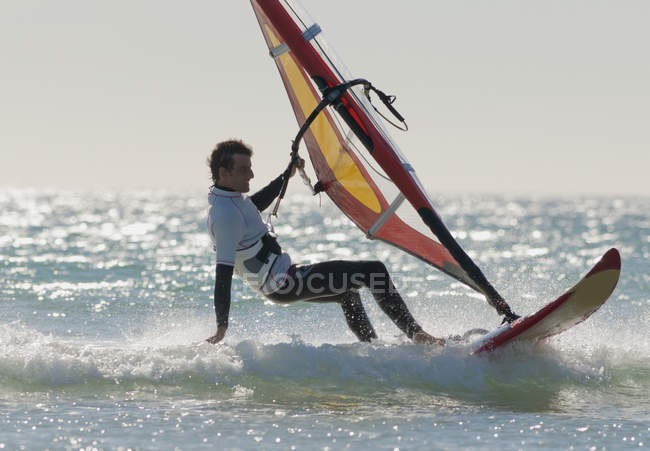 Adult extreme athlet on windsurfing board. Tarifa, Cadiz, Andalusia, Spain — Stock Photo