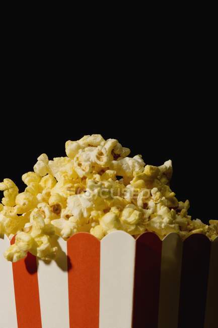 Salted tasty popcorn in bucket, closeup — Stock Photo
