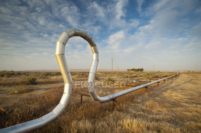Pipe In A Unique Shape In A Grassy Area; Mckittrick, California, United States of America — стоковое фото