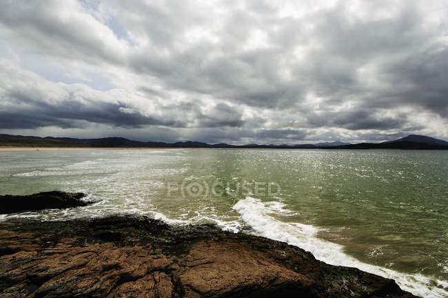 Vista de la costa y el mar ondulado - foto de stock